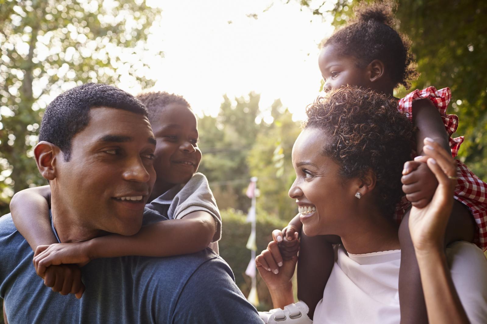 african-american-parents-giving-children-PC6M6GJ