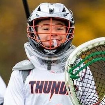 Youth lacrosse goalie making a save