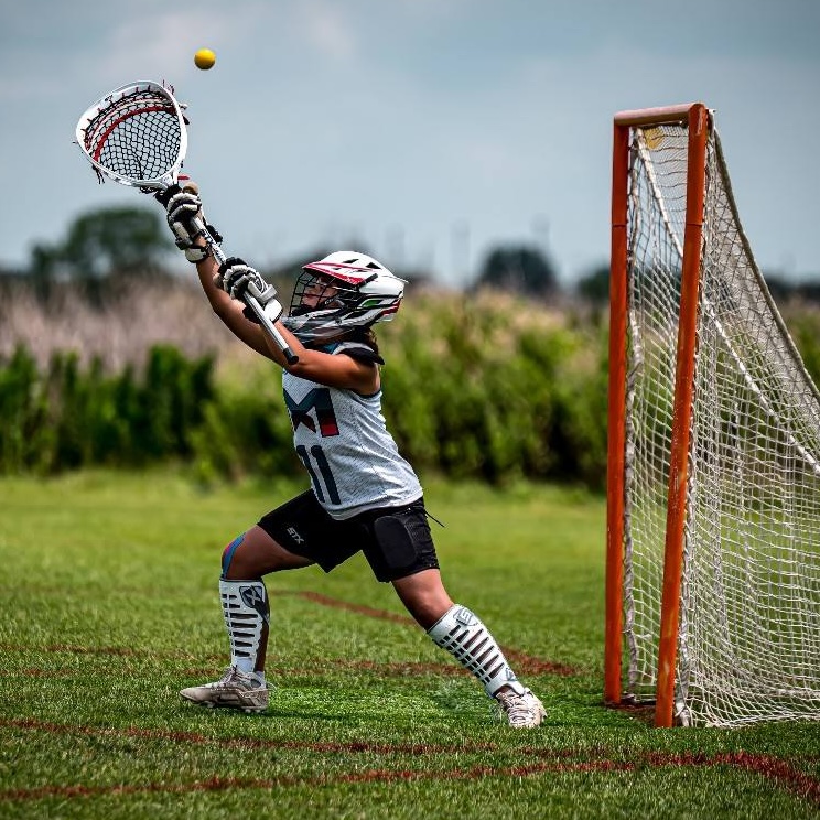 Youth lacrosse goalie in ready position