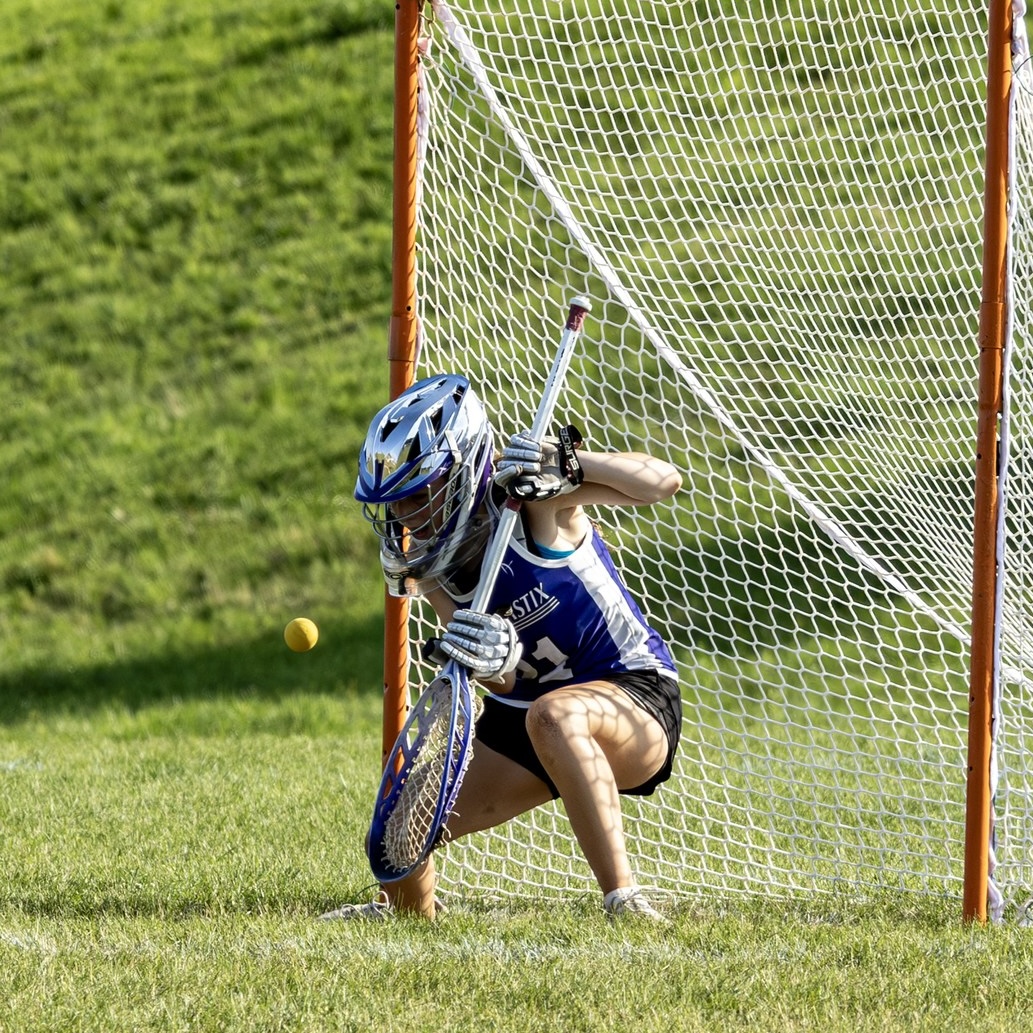 Youth lacrosse goalie celebrating