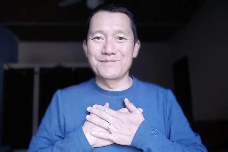 George Kao with his hands over his heart