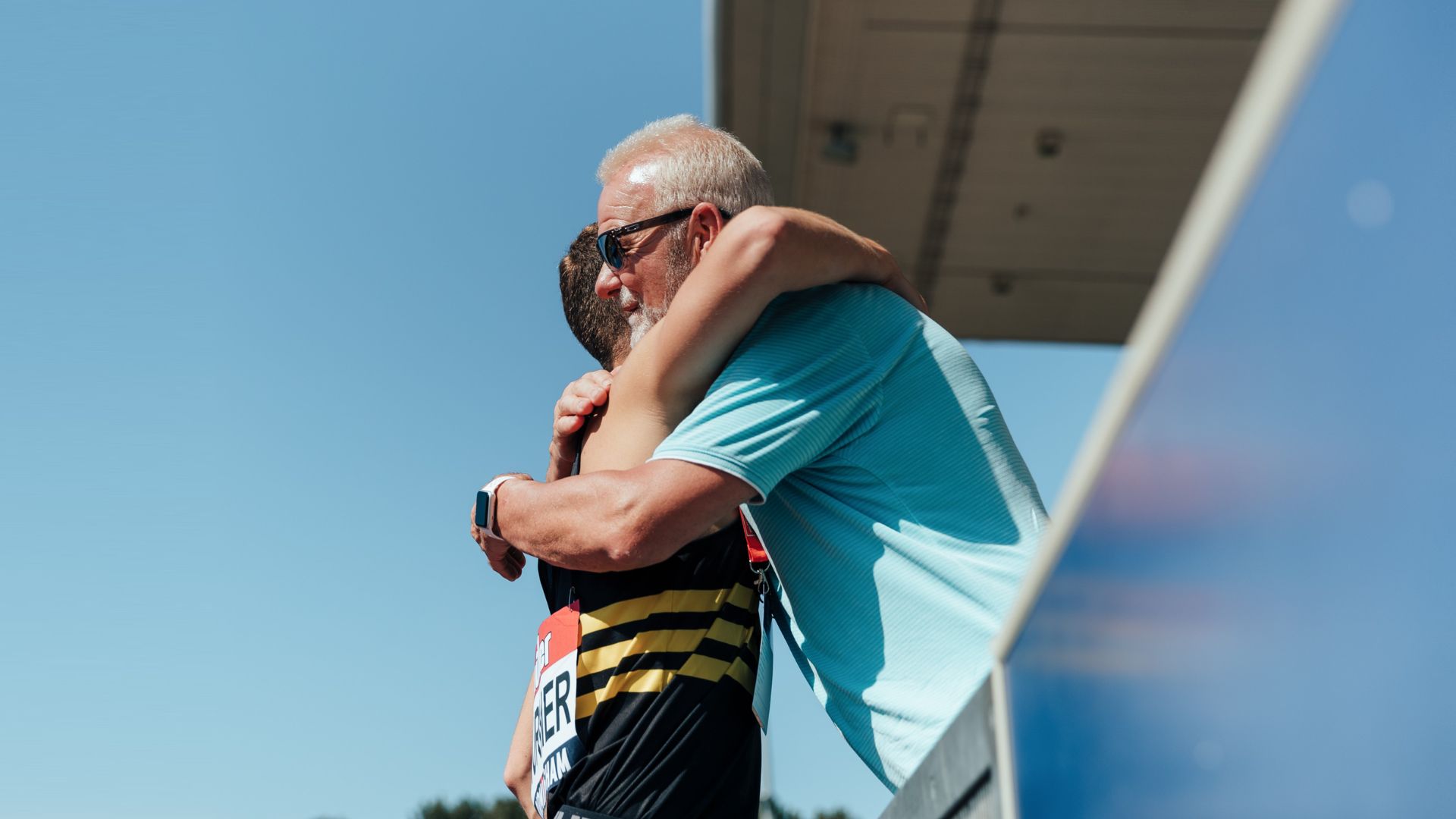 A parent supporting a young athlete
