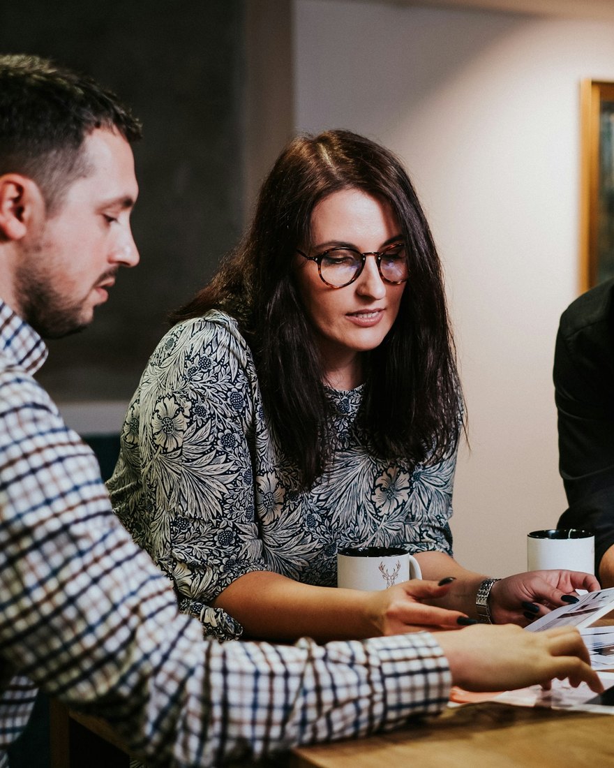 A professional services team reviewing documents together at a table