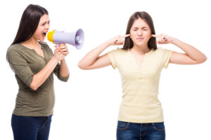 Mom using megaphone to yell at her teen daughter, the opposite of calm parenting