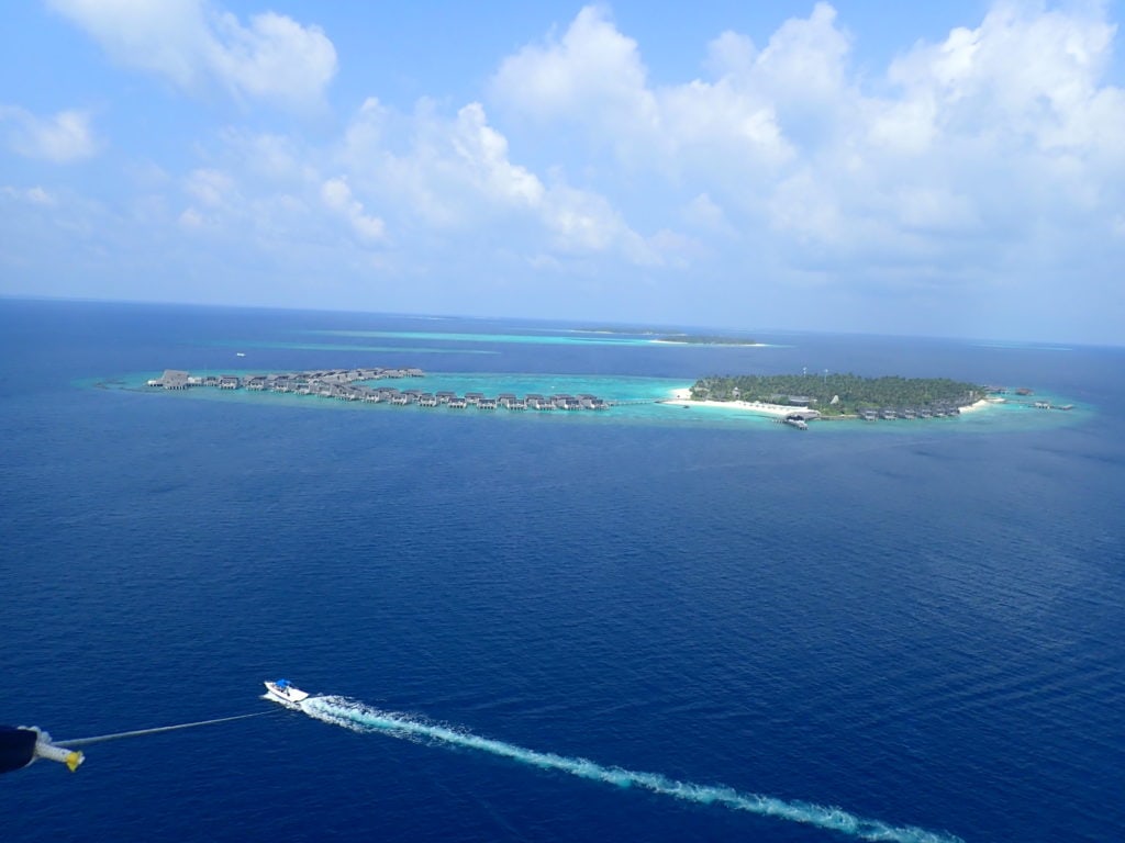 View of St. Regis Maldives resort while parasailing 