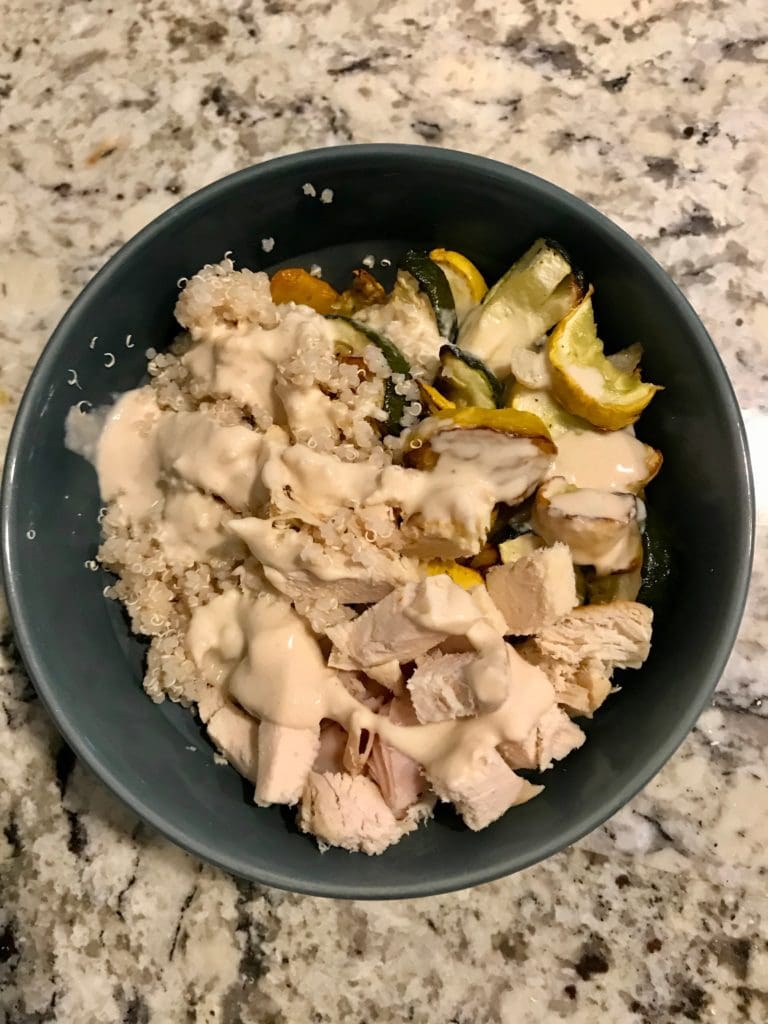 breakfast bowl quinoa, roasted vegetables, chicken, tahini lemon dressing