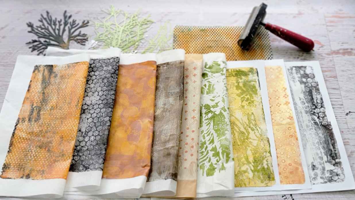 Assorted painted papers with textures and landscape marks